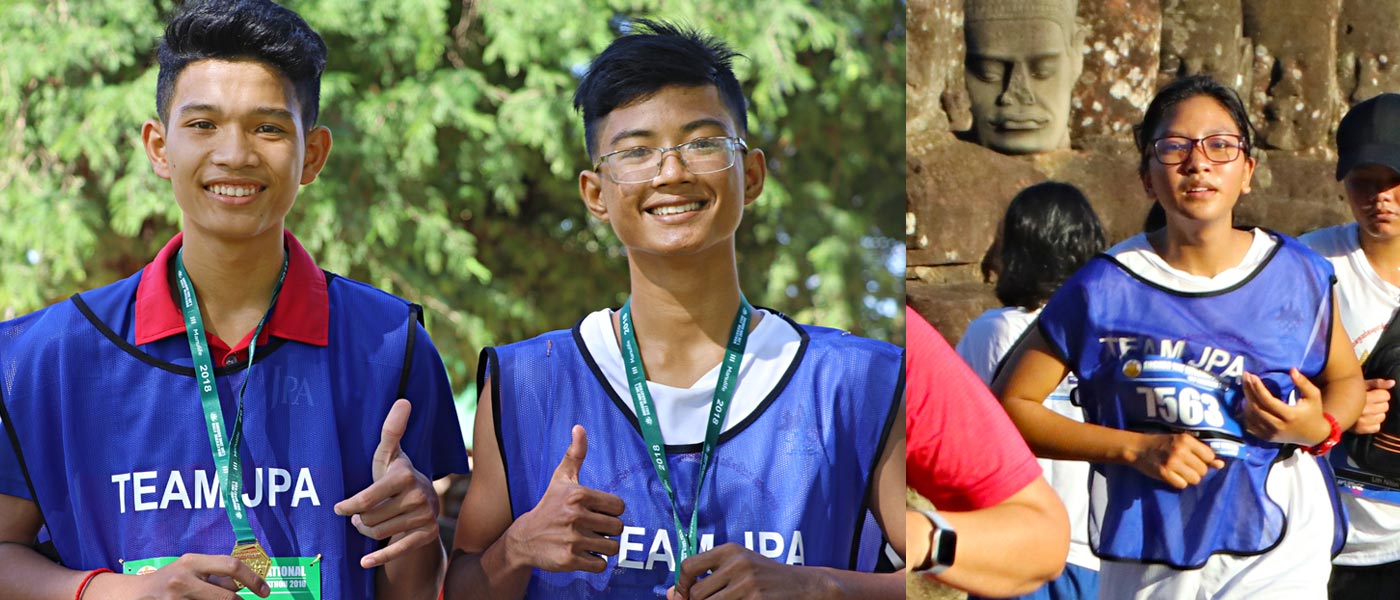 JPA students Sothea, Khemara, Alisa competing in the 23rd Angkor Wat International Half Marathon 2018. Jay Pritzker Academy, Siem Reap, Cambodia. Jay-Pritzker-Academy-Siem-Reap-Cambodia.