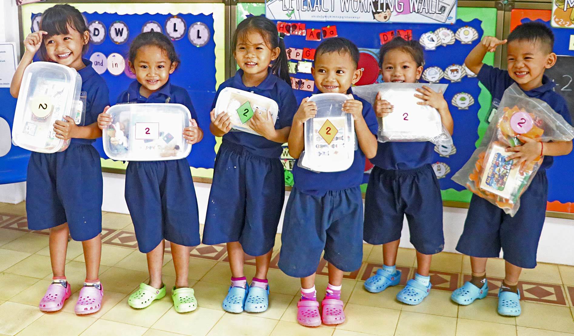 JPA Pre-Kindergarten Students Ready to Head Home with their Activity Packs. Jay Pritzker Academy, Siem Reap, Cambodia. Jay-Pritzker-Academy-Siem-Reap-Cambodia.